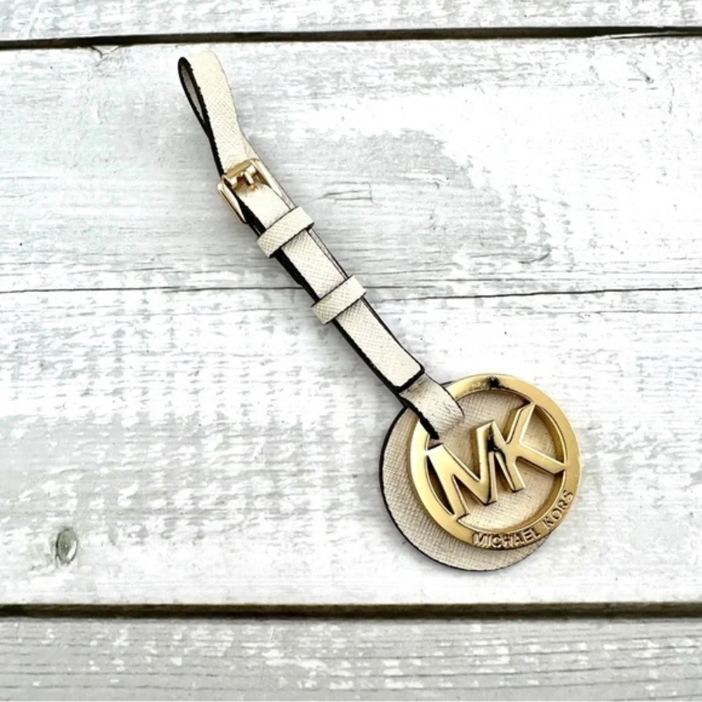 Michael Kors handbag charm.